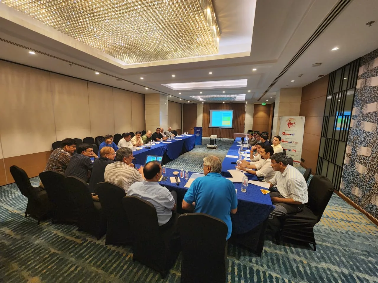 AOS executive members in a wide meeting-room discussion