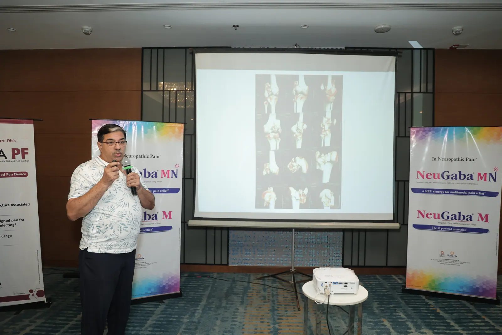 Clinical speaker presenting knee imaging during the scientific meeting