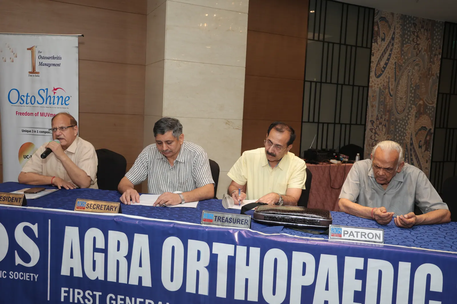 AOS office bearers seated at the General Body Meeting table