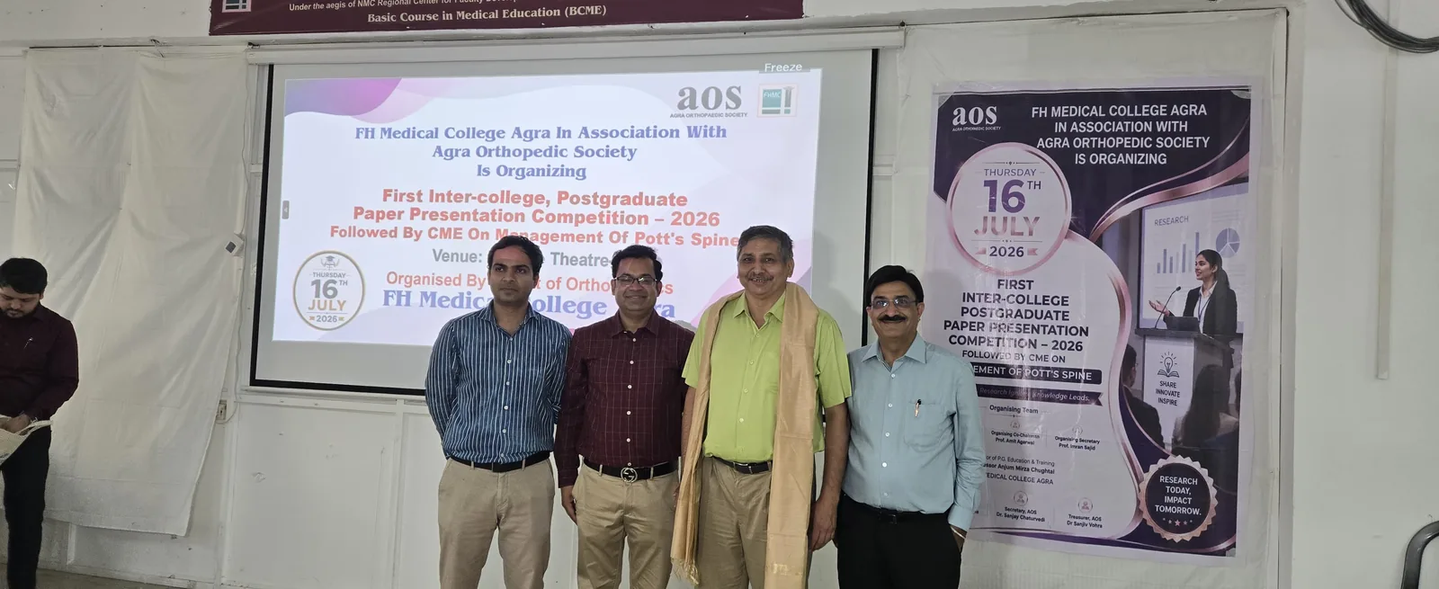 Faculty and participants photographed at the AOS PG competition backdrop